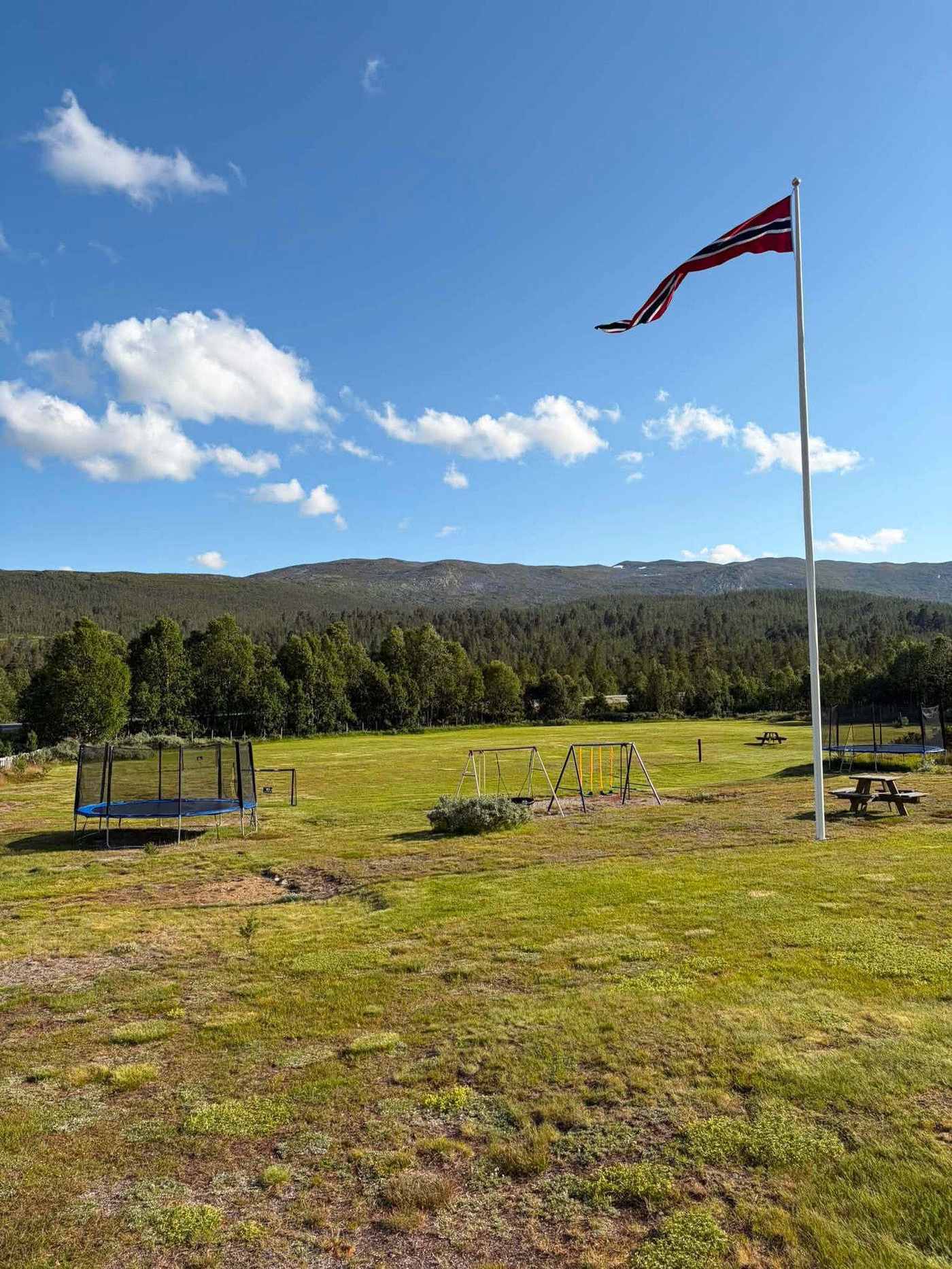 Trampoline and swings at the campsite playground